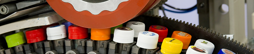 Image shows a printing process on bottle caps as an example of the application of printing inks for the beverage industry.